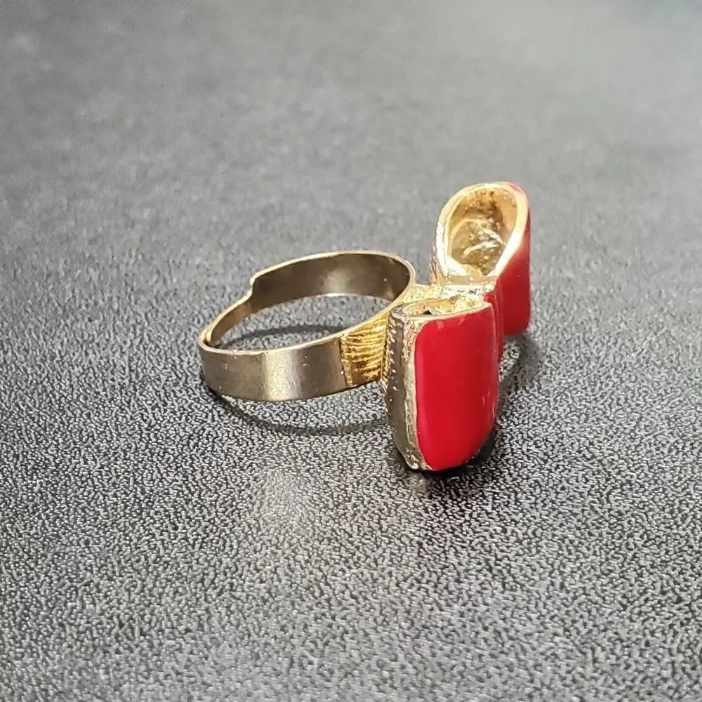 Gold tone red enamel bow ring currently a 7